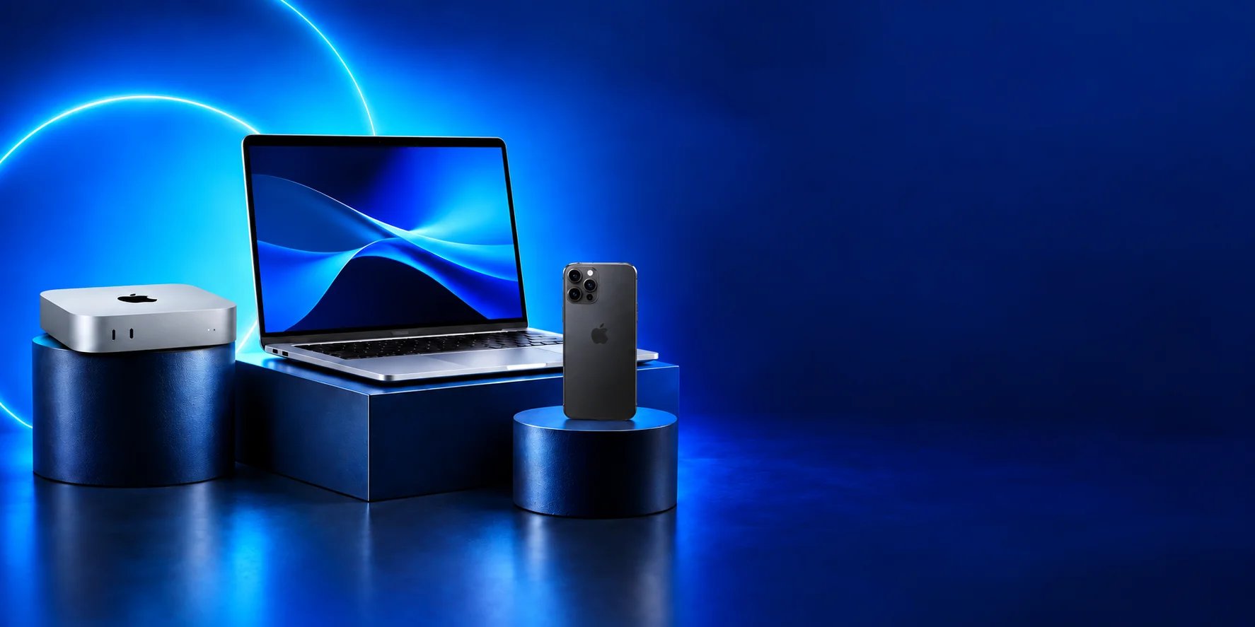 Mac mini, laptop and phone displayed against an electric blue backdrop